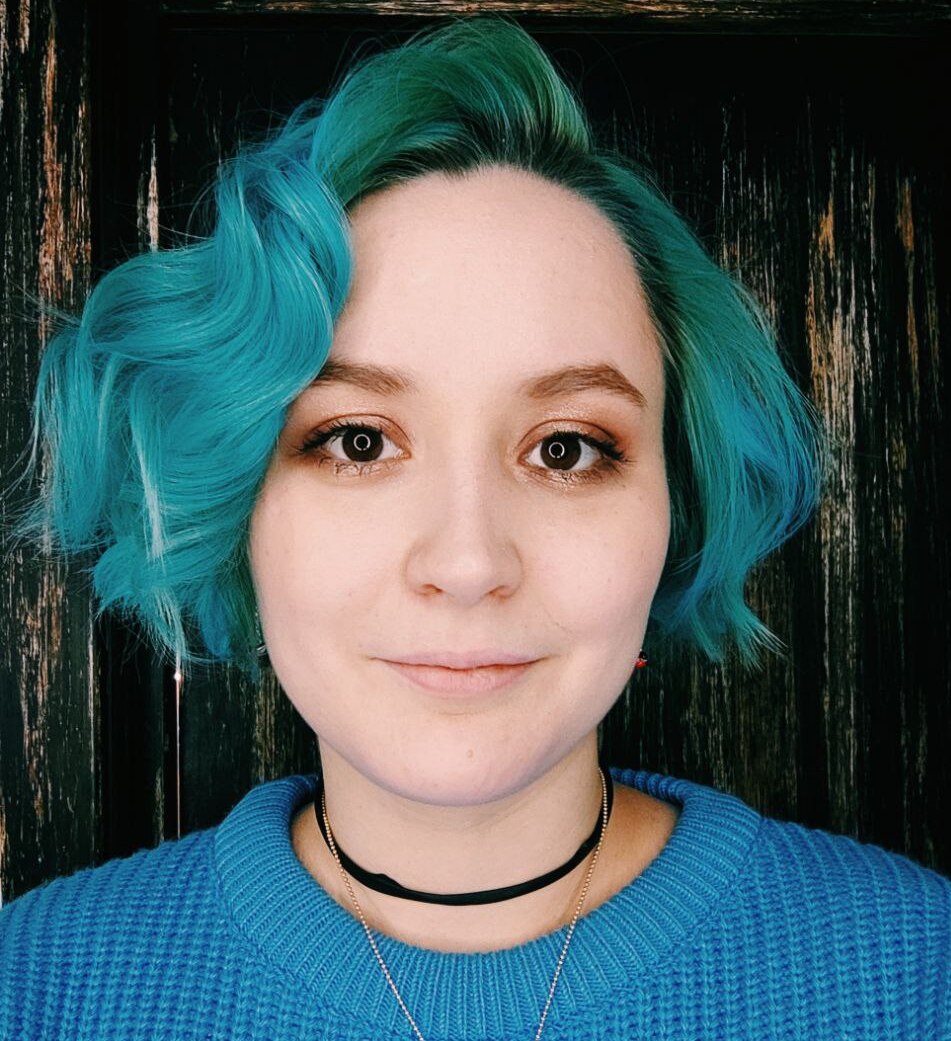 young woman with blue hair and blue sweater