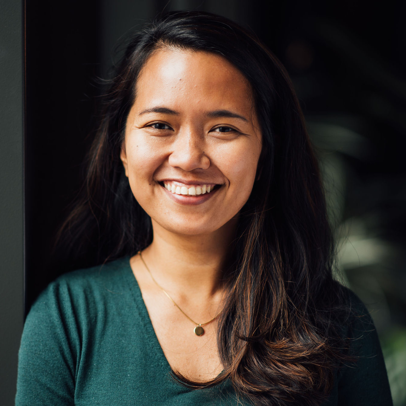 Headshot of a smiling woman with Asian origin